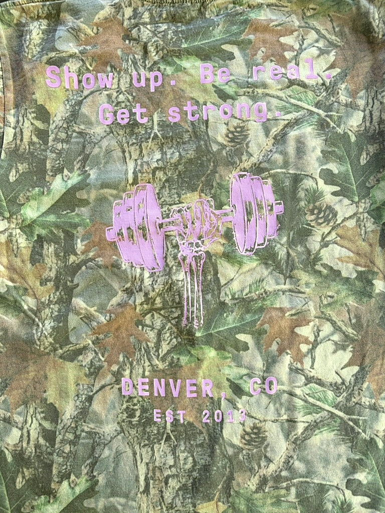 Close-up of the pink back print on the camo shop tee