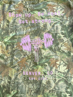 Close-up of the pink back print on the camo shop tee
