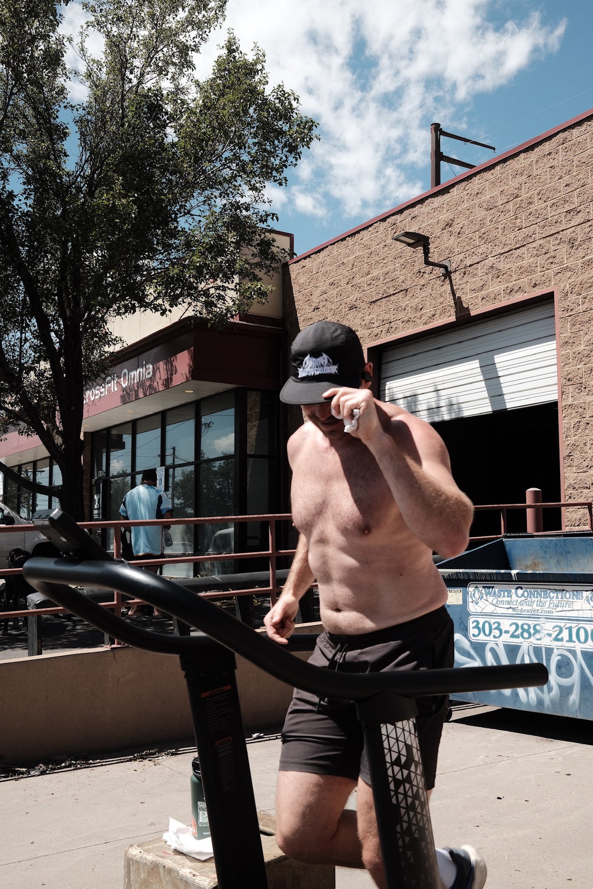 Athlete wearing the black Omnia running hat outside the gym
