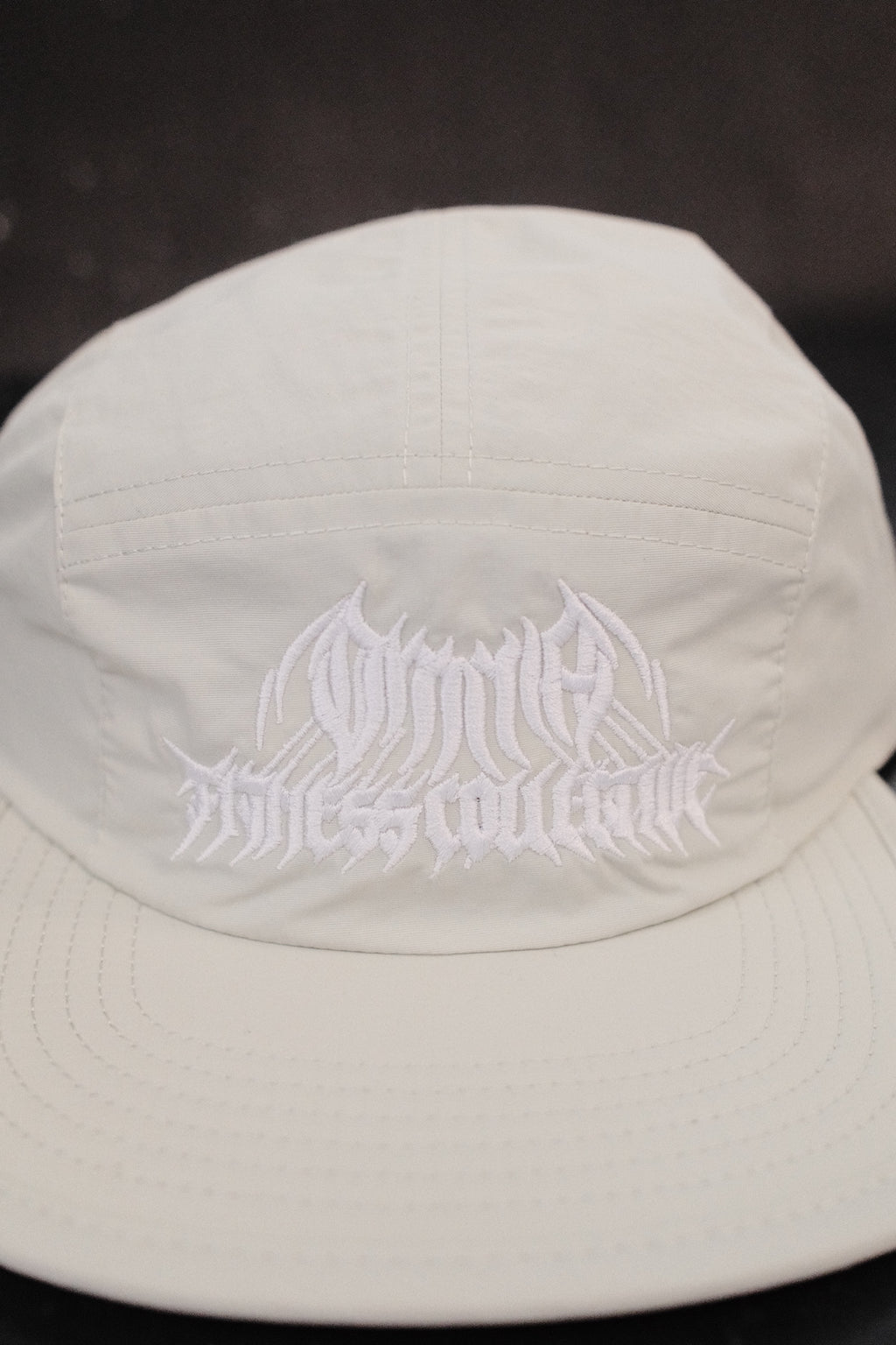 Close-up of the embroidered Metal Logo on the mint hat