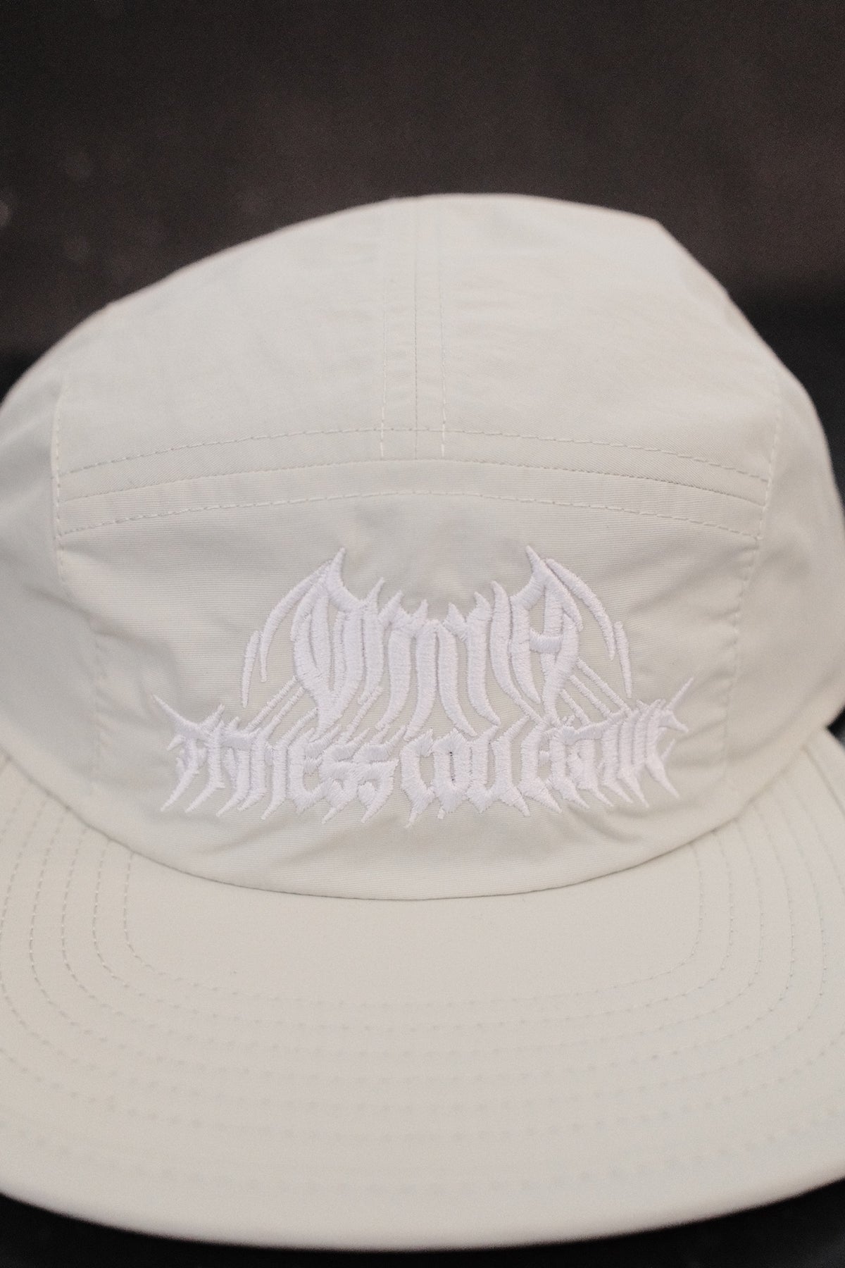 Close-up of the embroidered Metal Logo on the mint hat